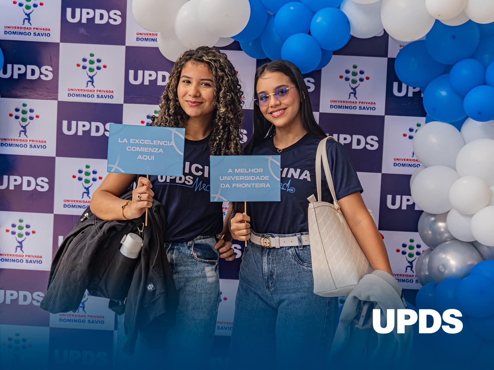 Estudiantes de UPDS Cobija con carteles que dicen La excelencia comienza aquí